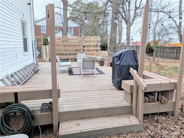 wooden terrace featuring a grill