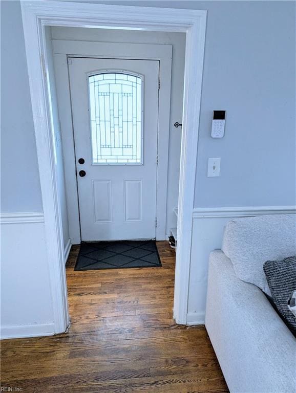 doorway to outside featuring dark wood-type flooring