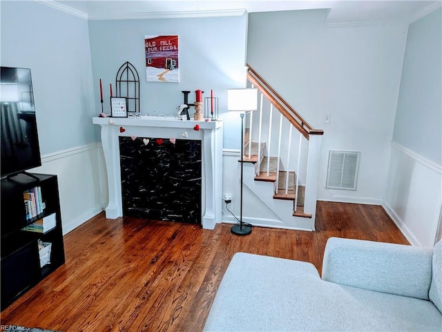 living room featuring ornamental molding and dark hardwood / wood-style flooring