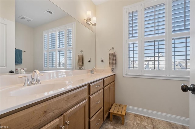 bathroom featuring plenty of natural light and vanity