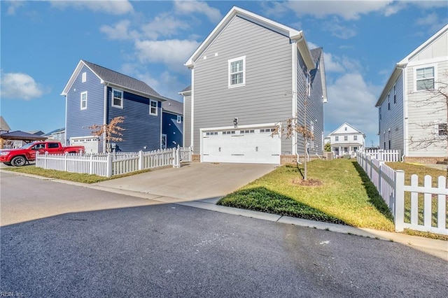 view of front of property featuring a garage and a front yard