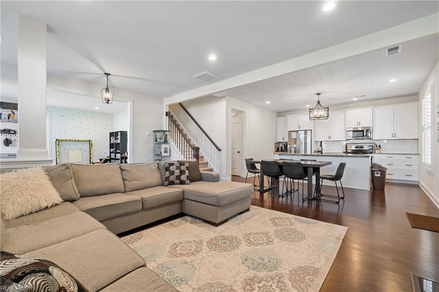 living room featuring dark hardwood / wood-style floors and a chandelier