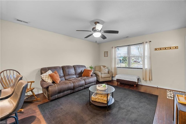 living room featuring hardwood / wood-style floors and ceiling fan