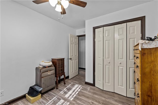 bedroom with hardwood / wood-style flooring, a closet, and ceiling fan