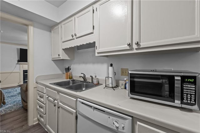 kitchen featuring white cabinetry, dishwasher, sink, and dark hardwood / wood-style floors