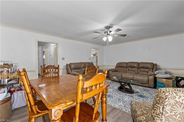 dining space featuring hardwood / wood-style flooring, ceiling fan, and crown molding