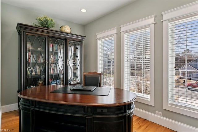 office space featuring a healthy amount of sunlight and light hardwood / wood-style flooring