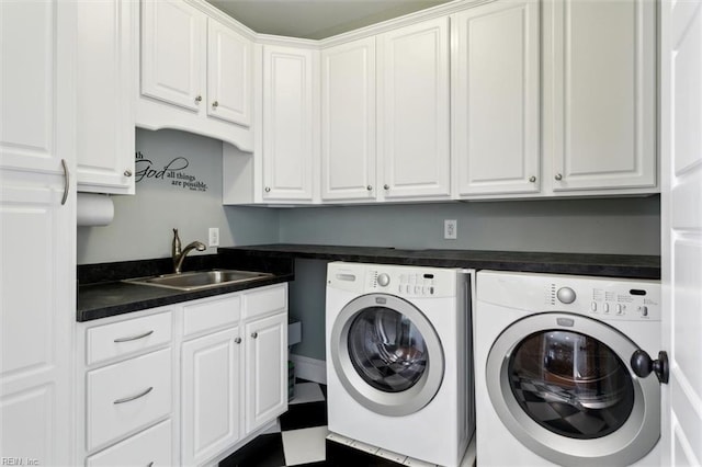 washroom featuring cabinets, independent washer and dryer, and sink