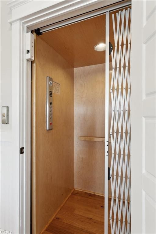 room details featuring elevator and hardwood / wood-style floors