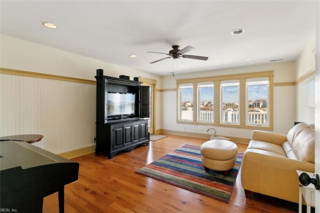 living room featuring hardwood / wood-style flooring and ceiling fan