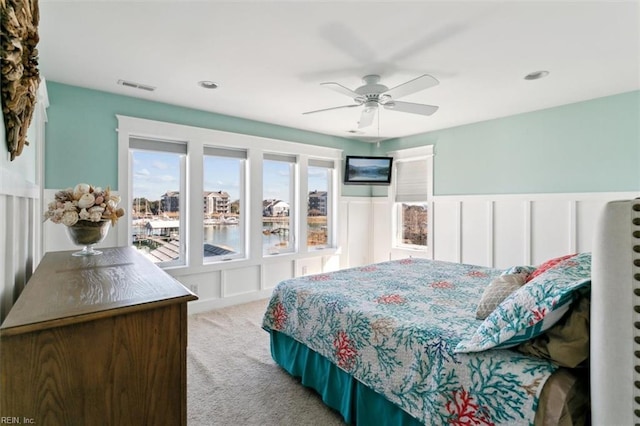 bedroom with ceiling fan and light carpet