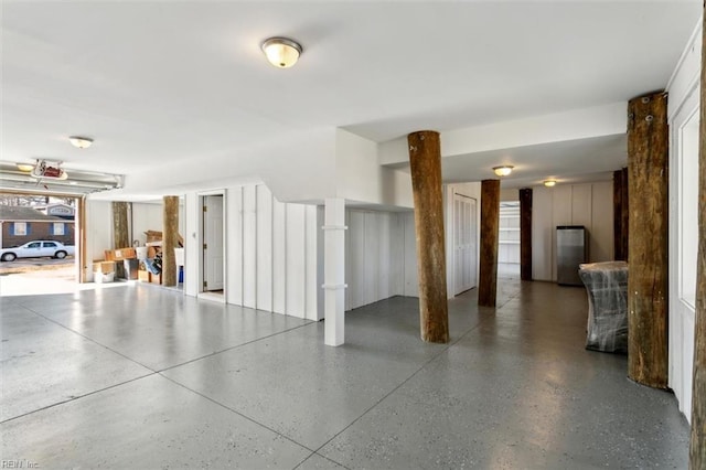 garage with stainless steel fridge