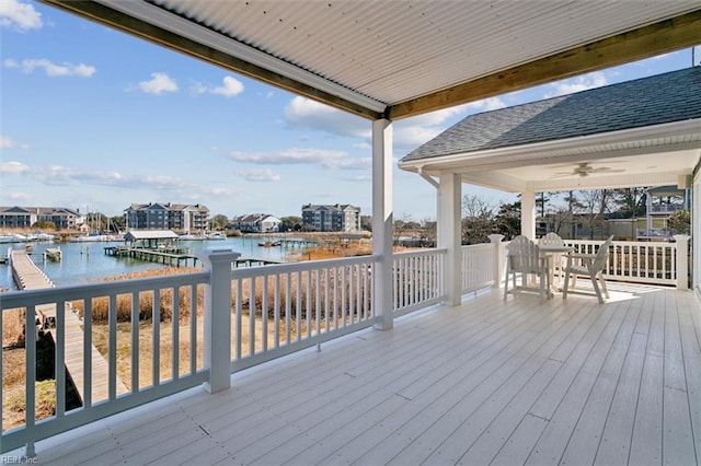 wooden terrace featuring a water view and ceiling fan