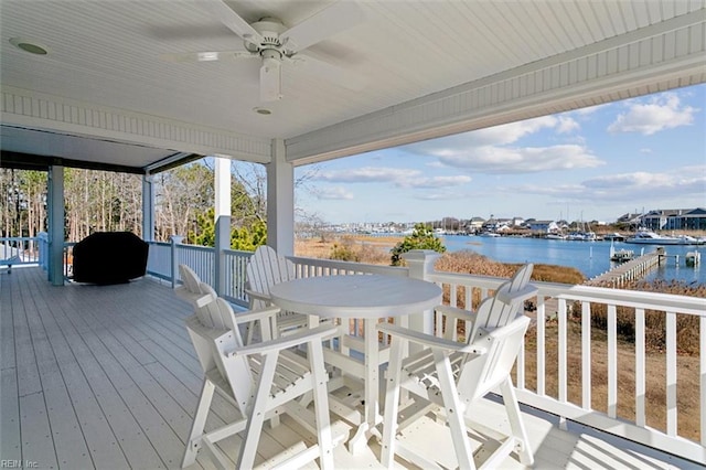 wooden deck featuring a water view and ceiling fan