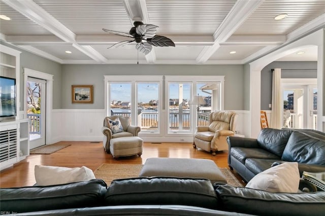 living room featuring beamed ceiling, plenty of natural light, coffered ceiling, and light hardwood / wood-style flooring