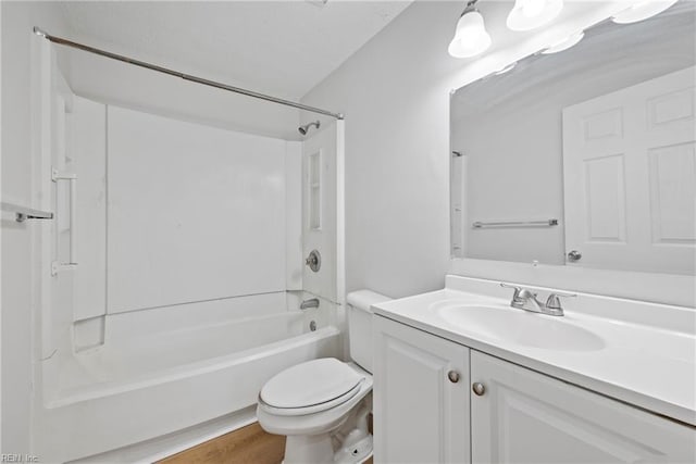 full bathroom featuring hardwood / wood-style flooring, vanity, washtub / shower combination, and toilet