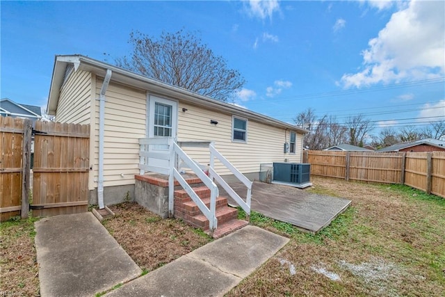 back of property featuring central AC unit