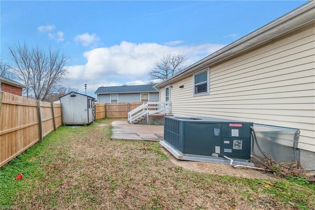 view of yard featuring a patio, cooling unit, and a storage shed