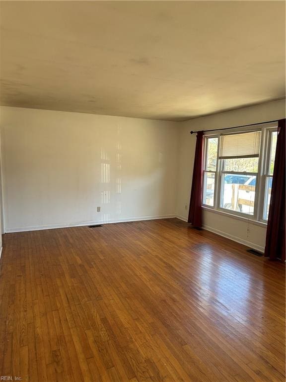 unfurnished room featuring dark hardwood / wood-style floors