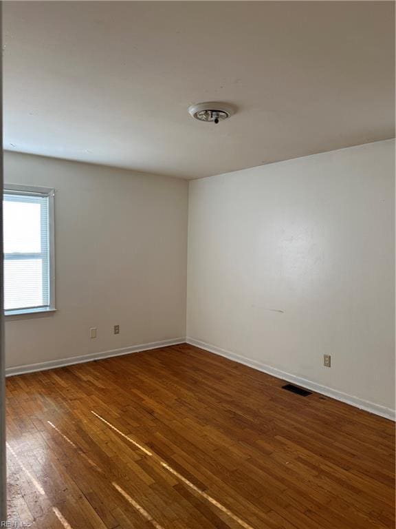 empty room featuring dark hardwood / wood-style flooring