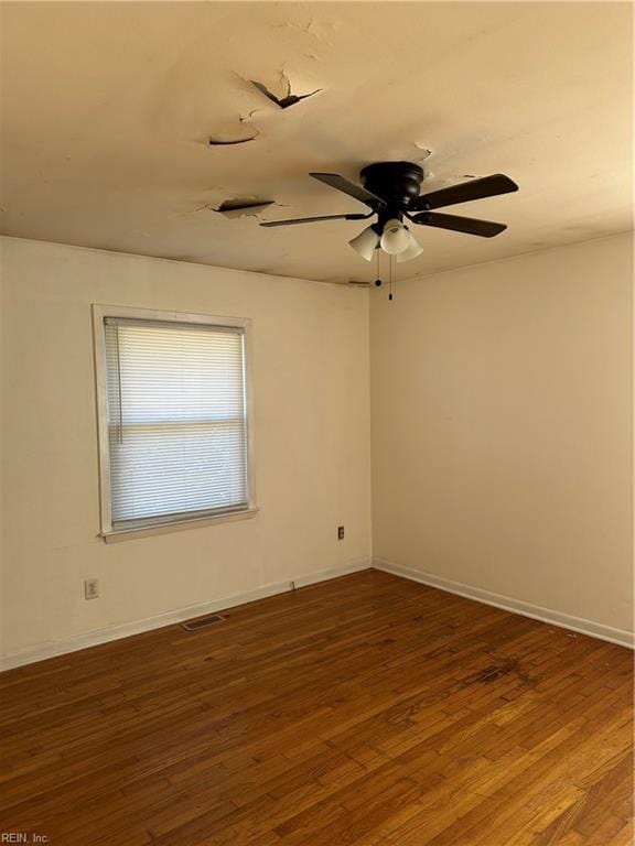 empty room with dark wood-type flooring and ceiling fan