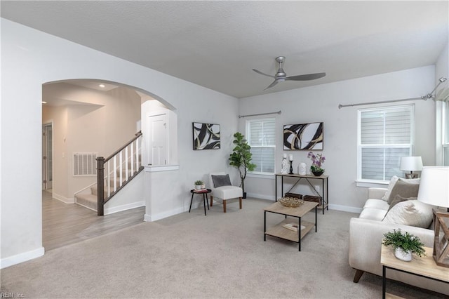 carpeted living room featuring ceiling fan