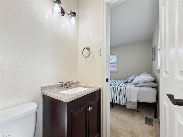 bathroom featuring vanity and toilet