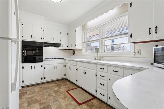 kitchen with sink, crown molding, white cabinetry, white gas stovetop, and oven