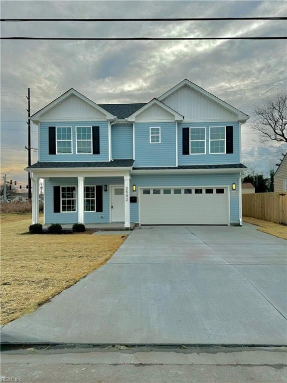 view of front of house with a garage and a front lawn