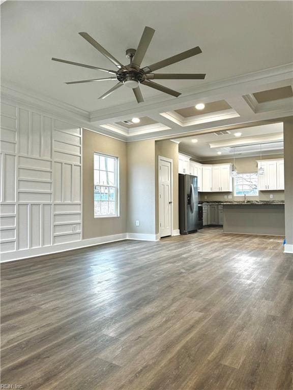 unfurnished living room with sink, crown molding, ceiling fan, dark hardwood / wood-style floors, and coffered ceiling