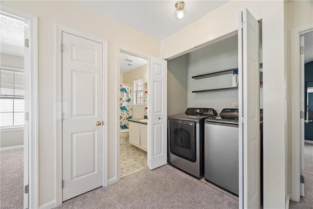 laundry room featuring separate washer and dryer, plenty of natural light, and light colored carpet