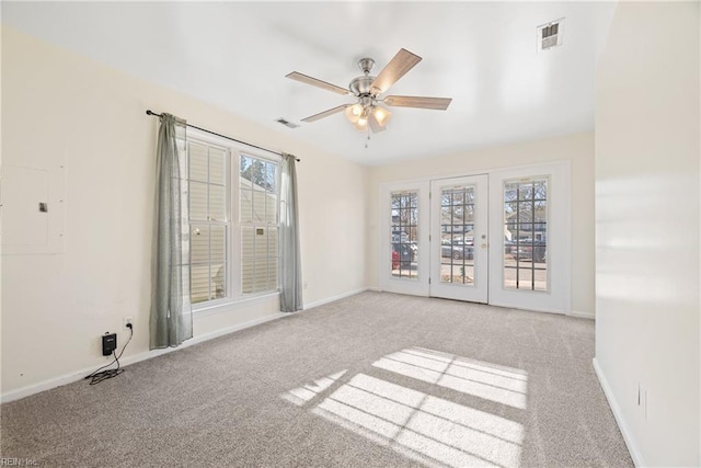 carpeted empty room with ceiling fan and a healthy amount of sunlight