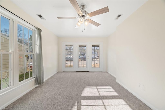 carpeted spare room with ceiling fan