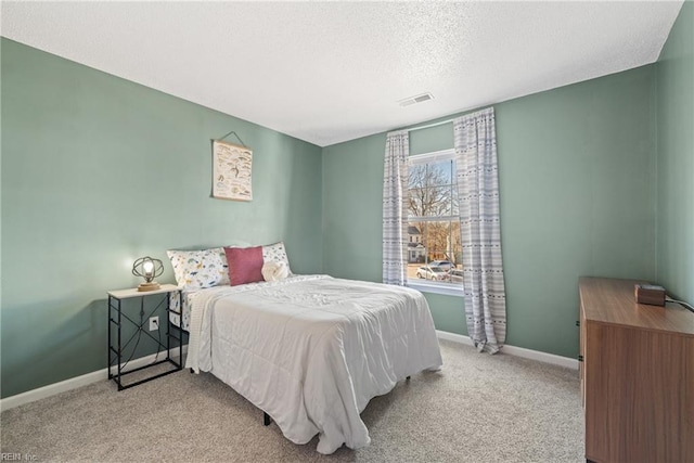 carpeted bedroom with a textured ceiling