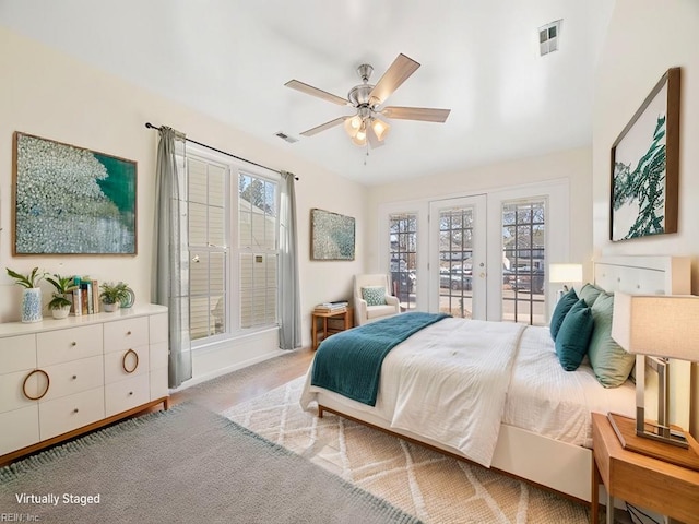 carpeted bedroom with french doors, ceiling fan, access to exterior, and multiple windows