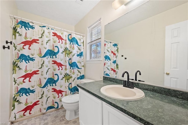 bathroom featuring vanity, toilet, and a shower with shower curtain