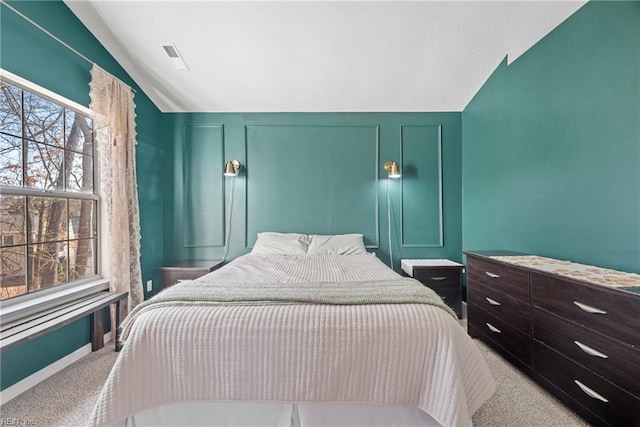 carpeted bedroom featuring lofted ceiling