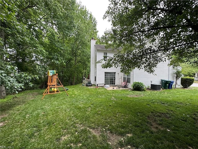 view of yard featuring a playground and central AC