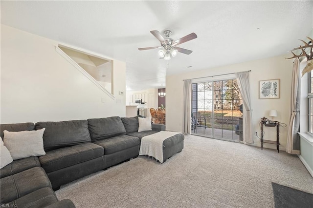 carpeted living room with ceiling fan