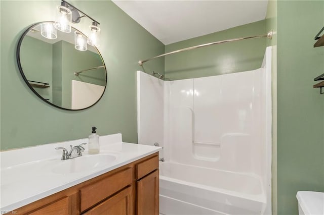 full bathroom with vanity, washtub / shower combination, and toilet