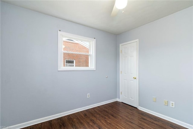 empty room featuring dark wood-type flooring and ceiling fan