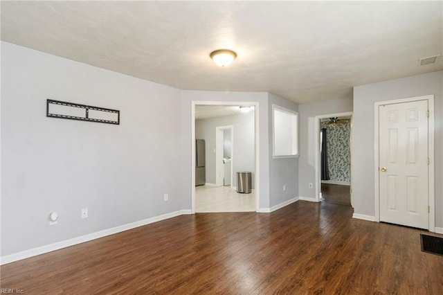 unfurnished room with dark hardwood / wood-style flooring