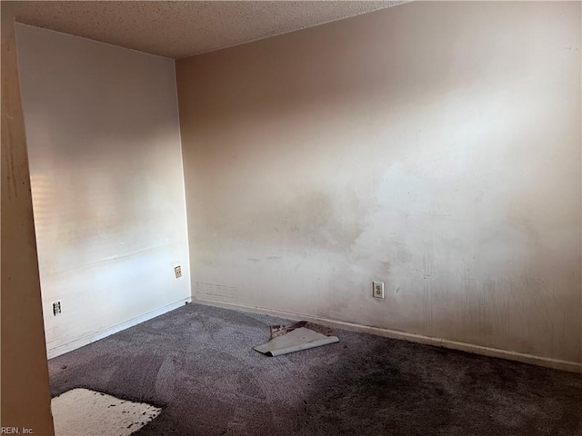 carpeted spare room featuring a textured ceiling