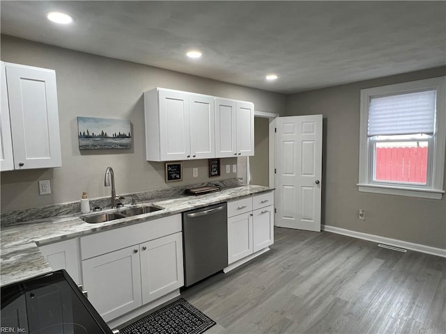 kitchen with white cabinetry, dishwasher, and sink