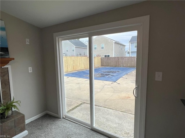 doorway to outside featuring carpet floors