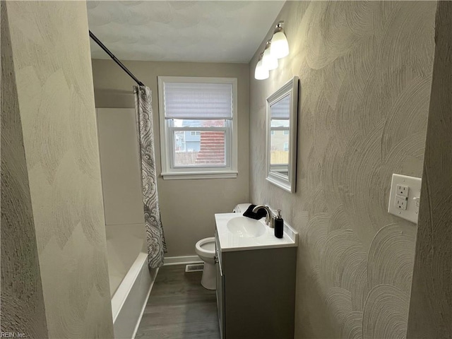 full bathroom with vanity, shower / tub combo, hardwood / wood-style flooring, and toilet