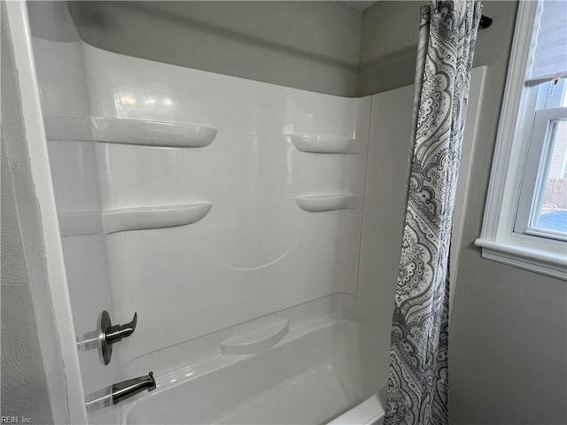 bathroom with shower / bathtub combination with curtain