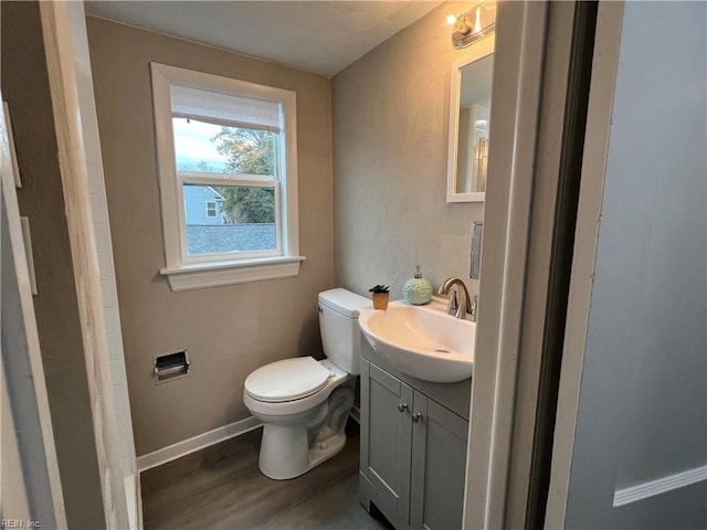 bathroom with vanity, hardwood / wood-style floors, and toilet