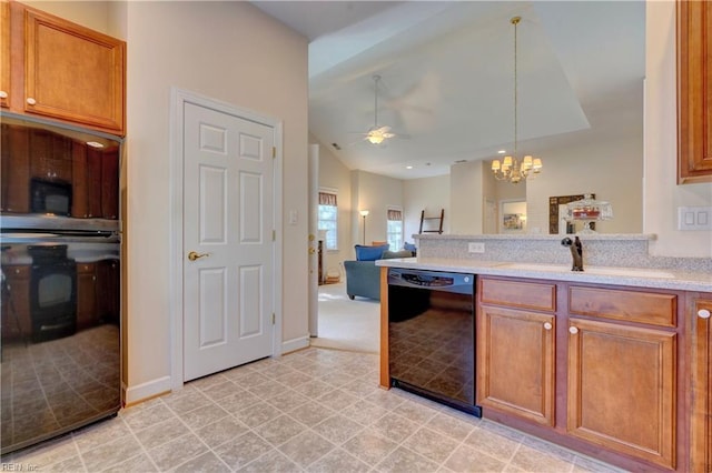 kitchen with lofted ceiling, sink, hanging light fixtures, ceiling fan with notable chandelier, and black appliances