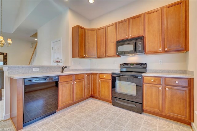 kitchen featuring decorative light fixtures, sink, an inviting chandelier, and black appliances